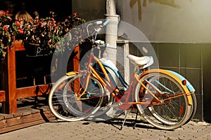 beautiful colorful bicycles parked at old sunny european street, summer concept