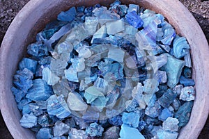 Beautiful colorful blue stones in clay vessels background