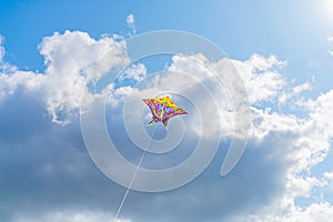 Beautiful colorful butterfly kite against the sky and clouds, freedom vacation travel concept