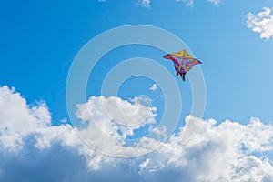 Beautiful colorful butterfly kite against the sky and clouds, freedom vacation travel concept