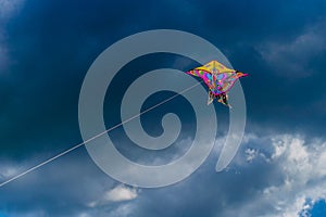 Beautiful colorful butterfly kite against the sky and clouds, freedom vacation travel concept