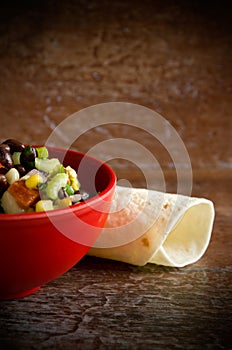 Beautiful, Colorful and Delicious Mexican Salad in a Red Bowl with Tortillas