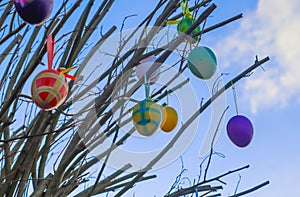 Beautiful and colorful easter egg decoration hanging in a tree