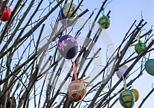 Beautiful and colorful easter egg decoration hanging in a tree