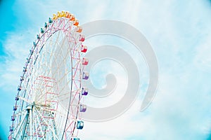 Beautiful and colorful of Ferris wheel with clouds blue sky background