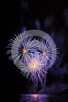 Beautiful colorful fireworks on water. Purple fireworks reflection. Brno dam. International Fireworks Competition Ignis Brunensis.