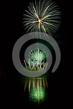 Beautiful colorful fireworks on the water surface with a clean black background. Fun festival and international contest of Firefig