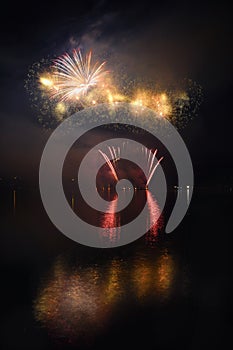 Beautiful colorful fireworks on the water surface with a clean black background. Fun festival and international contest of Firefig