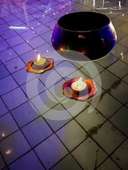 Beautiful and colorful floating candles in pond water, buddhist detail and background