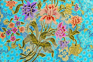 Beautiful colorful flowers on batik background