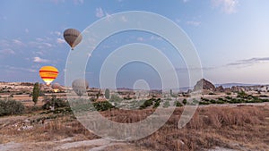 Beautiful colorful hot air balloons take off and flying in clear morning sky timelapse in Cappadocia, Turkey