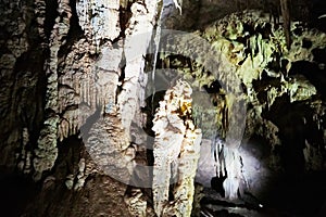 Beautiful colorful and illuminated cave with stalactites and stalagmites