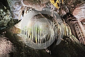 Beautiful colorful and illuminated cave with stalactites and stalagmites