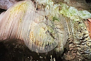 Beautiful colorful and illuminated cave with stalactites and stalagmites