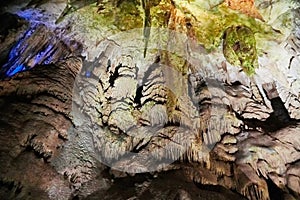 Beautiful colorful and illuminated cave with stalactites and stalagmites