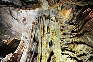 Beautiful colorful and illuminated cave with stalactites and stalagmites