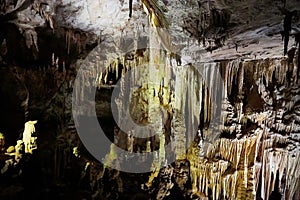 Beautiful colorful and illuminated cave with stalactites and stalagmites
