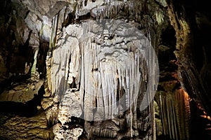 Beautiful colorful and illuminated cave with stalactites and stalagmites