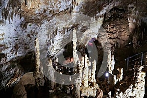 Beautiful colorful and illuminated cave with stalactites and stalagmites