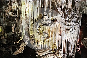 Beautiful colorful and illuminated cave with stalactites and stalagmites