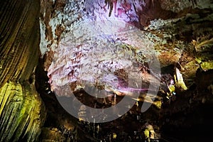 Beautiful colorful and illuminated cave with stalactites and stalagmites