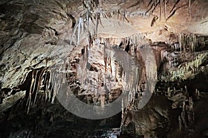 Beautiful colorful and illuminated cave with stalactites and stalagmites