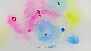 Beautiful colorful ink in water, ink drop. Falling blue, red, yellow ink in water with white background.