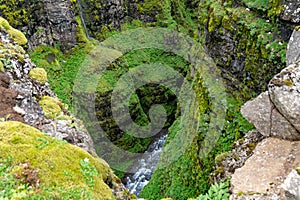 Beautiful colorful mossy canyon - Glymur Waterfall in Iceland