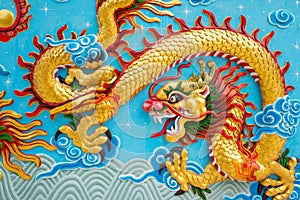 Beautiful colorful painting low relief dragon sculpture in Chinese temple wall, Kanchanaburi Thailand