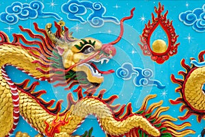 Beautiful colorful painting low relief dragon sculpture in Chinese temple wall, Kanchanaburi Thailand