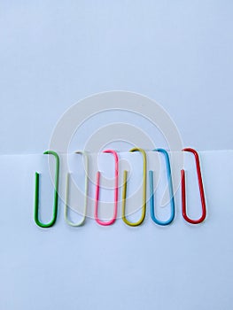 Beautiful colorful paper clip on white background