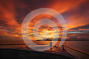 Beautiful and colorful red orange sunset in Koh Lanta Island, Thailand. View from a boat