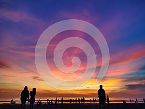 Beautiful and colorful sky when sunset with shillouette people