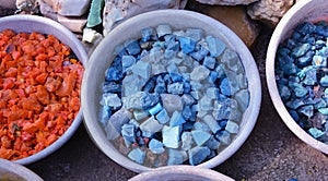 Beautiful colorful stones in clay vessels background