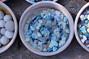 Beautiful colorful stones in clay vessels close up for background