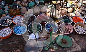 Beautiful colorful stones in clay vessels with Indian tarazu to measure the weight
