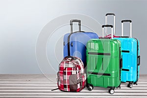 Beautiful Colorful suitcases on wooden background