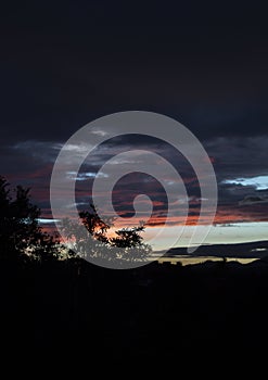 Beautiful Colorful sunset in the city with cloudy sky and mountains