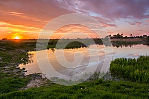 Beautiful colorful sunset at countriside lake