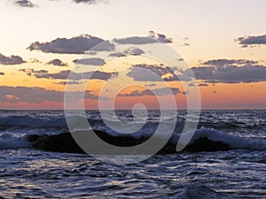 Beautiful Colorful Sunset Dawn Over Sea Waves Hitting Rocky Stone Beach