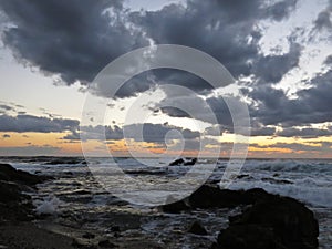 Beautiful Colorful Sunset Dawn Over Sea Waves Hitting Rocky Stone Beach