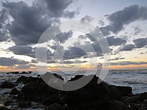 Beautiful Colorful Sunset Dawn Over Sea Waves Hitting Rocky Stone Beach