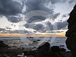 Beautiful Colorful Sunset Dawn Over Sea Waves Hitting Rocky Stone Beach