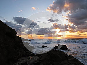 Beautiful Colorful Sunset Dawn Over Sea Waves Hitting Rocky Stone Beach