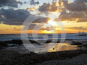 Beautiful Colorful Sunset Dawn Over Sea Waves Hitting Rocky Stone Beach