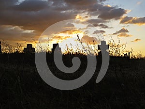 Beautiful Colorful Sunset Over Cross on Churchyard Cemetery Graveyard