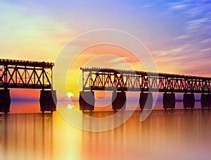 Beautiful colorful sunset or sunrise with broken bridge and cloudy sky