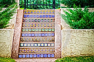 Beautiful colorful tuscan Mexican tile outdoor steps surrounded by stucco walls and landscapting