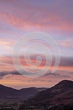 Beautiful colorful Winter sunset landscape over Skiddaw range looking towards Bassenthwaite Lake in Lake District