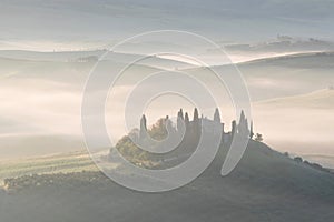 Beautiful colors of green spring panorama landscape of Tuscany. Most popular place in Italy. Green fields and blue sky and Cypress